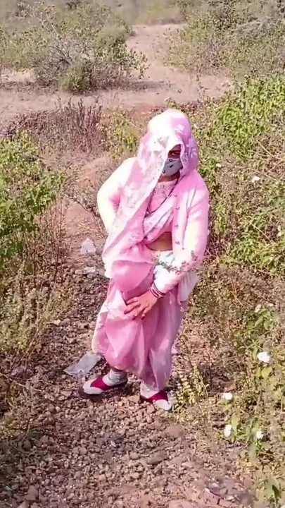 Sister-in-law is walking on the bridge by the roadside, getting down on the shore, sister-in-law started taking her… | Clip 1