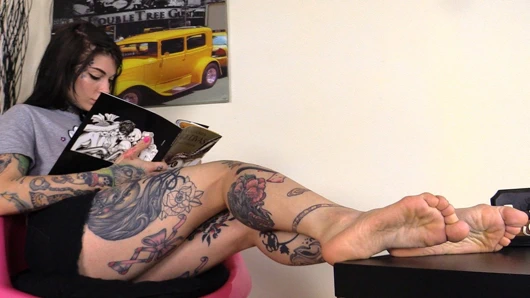 Yalınayak dövmeli kız ayak parmaklarını esnetiyor