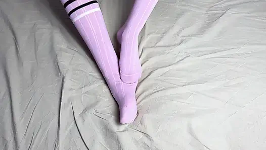Pink socks in hands of mistress with blue nails in solo video