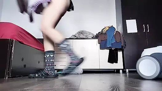 Amateur mom cleans naked with vacuum cleaner in the house.