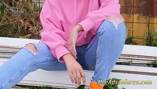 Hipster girl pee in her jeans - changing her wet shorts into dry pants