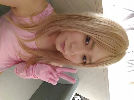A blonde cross-dressing boy masturbated in a pink leotard, knee socks and gloves