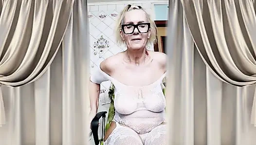 Neşeli ev hanımı Lukerya mutfakta açık, şeffaf beyaz tulumla flört ediyor.