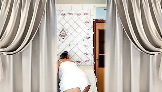 Real home solo of a mature woman in a small cozy kitchen.