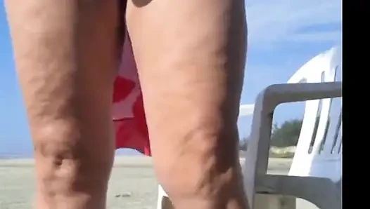 Hot crown sunbathing on the beach in transparent micro bikini