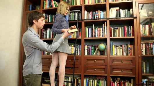Cum hungry milf Judith Angel seduces her younger man in the library with a peek up her miniskirt.