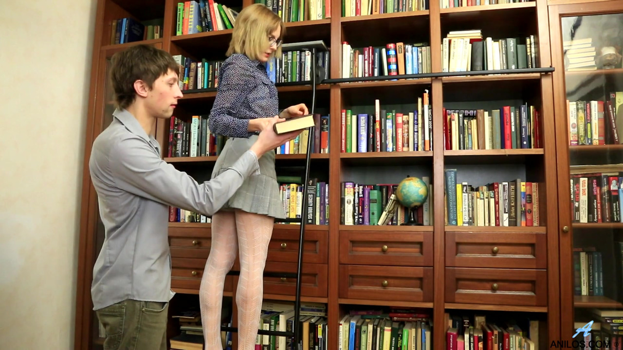 Cum hungry milf Judith Angel seduces her younger man in the library with a peek up her miniskirt.