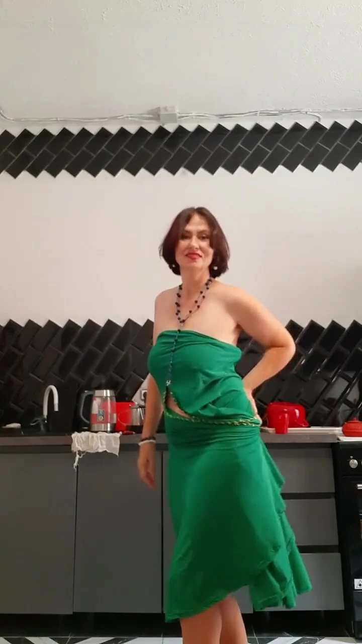 Her beautiful body is covered by a tight-fitting dress