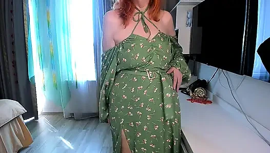 Hot redhead girl slowly undresses  Green floral dress, open back, high slit, stockings and red shoes