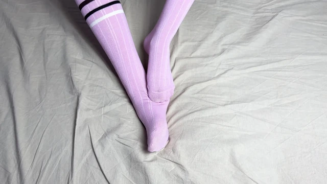 Pink socks in hands of mistress with blue nails in solo video