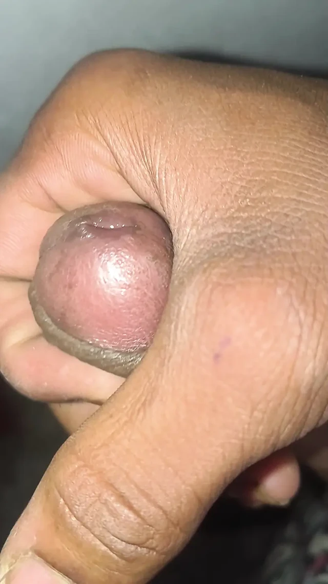 Young boy massages his big penis in a closed room