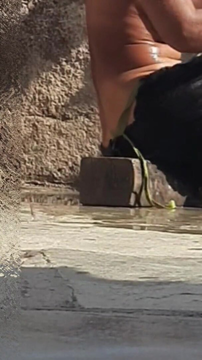 Indian sister-in-law is bathing in the open courtyard of the house, putting a finger in her burrow and rubbing the… | Clip 1