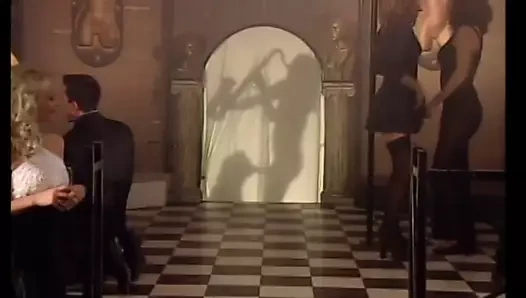 Sarışın ve esmer hatunlar, seks partilerinin gerçekleştiği bir malikaneye gelirler.