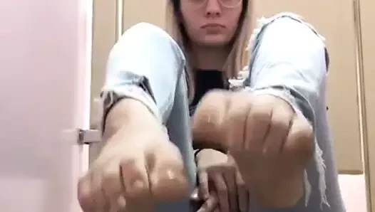 geeky blonde shows her feet in jeans