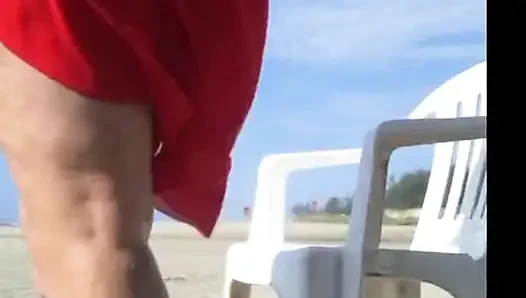 Hot crown sunbathing on the beach in transparent micro bikini