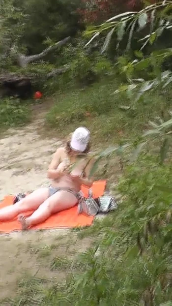 Memorable moment from "Wild beach. Random passerby guy peeps on sunbathing topless beautiful Milf on the river bank"