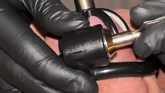 Athena plays with Nikos's cock while it's locked in chastity