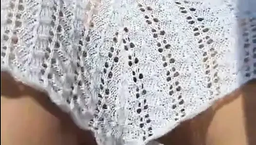 Hot crown sunbathing on the beach in transparent micro bikini