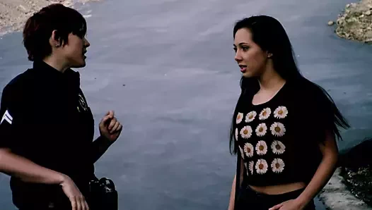 Minyon kız polis tarafından kontrol ediliyor ve soyunması gerekiyor, bu sırada itaatkar bir şekilde kıçını havaya kaldırıyor