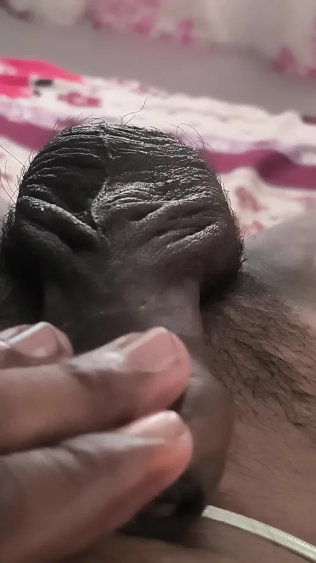 A man experiences pleasure by masturbating his penis with his hand and massaging it with coconut oil.