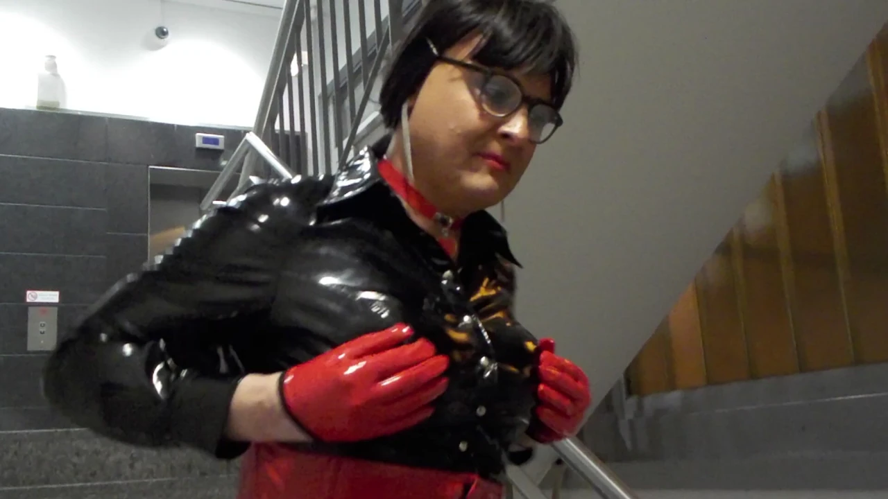 Tranny in a hot vinyl outfit flaunts herself in public parking garage