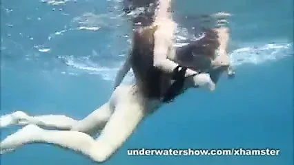 Julia and Masha are swimming nude in the sea