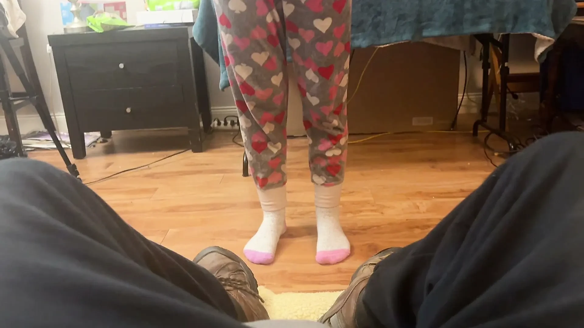 girl takes cares of mans feet after work. she takes off his boots and socks and smells them deeply