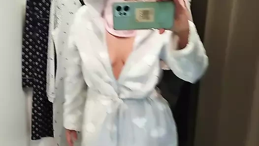 Sexy mom tries on pantyhose. Sexy brunette tries on clothes in fitting room.