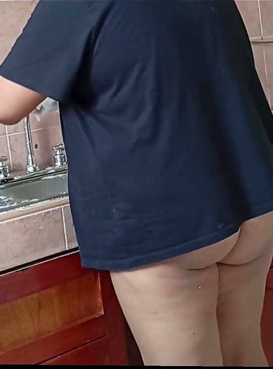 Tombul üvey anne mutfağı yıkıyor ve temiziyor