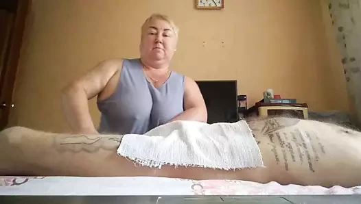 She massages my legs and jerks off my cock